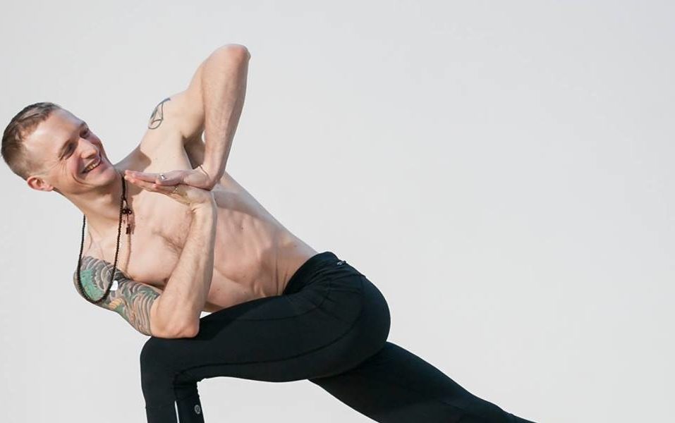 Why do a Power Yoga Teacher Training? 3 A man holding a bound side angle pose