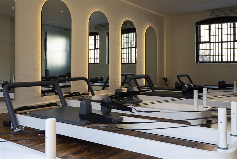 Arched mirror alcoves in the reformer room at PYC Studios